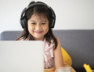 a girl with headphones and a laptop