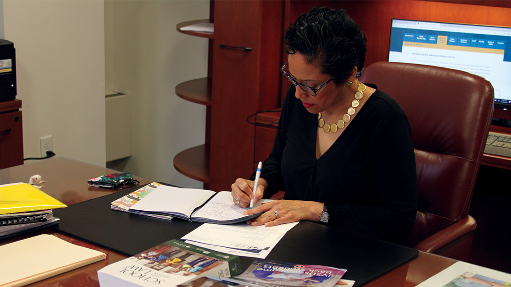 NSBA Executive Director and CEO Anna Maria Chávez writes at her desk