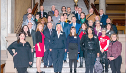 members of the Indiana school boards association smile for a group photo in the Indiana legislative building