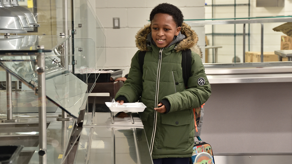 A student stands in line in the new cafeteria that opened in 2023 in Michigan's Pontiac School District.